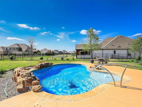 a view of a swimming pool and lounge chairs