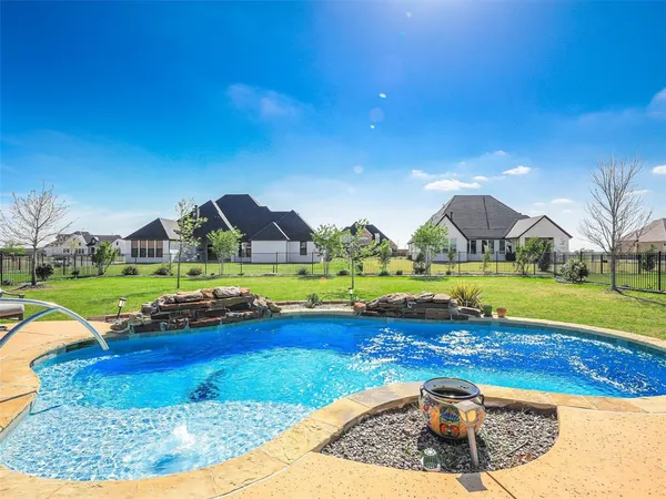 a view of swimming pool with lawn chairs and couches