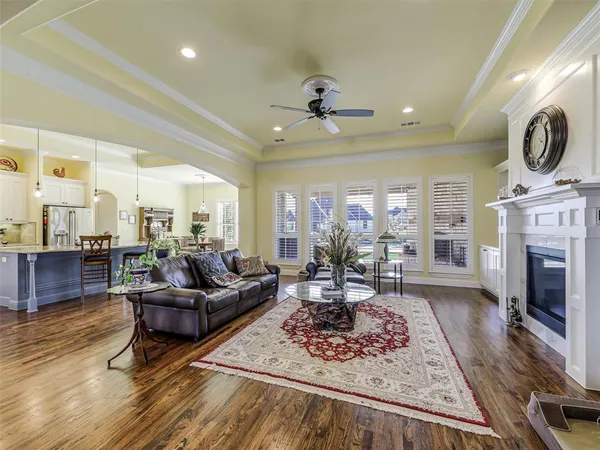 a living room with furniture a fireplace a rug and a window