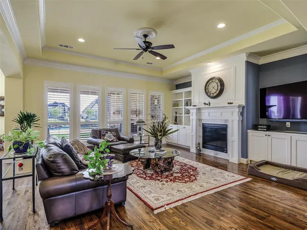 a living room with furniture a fireplace and a flat screen tv