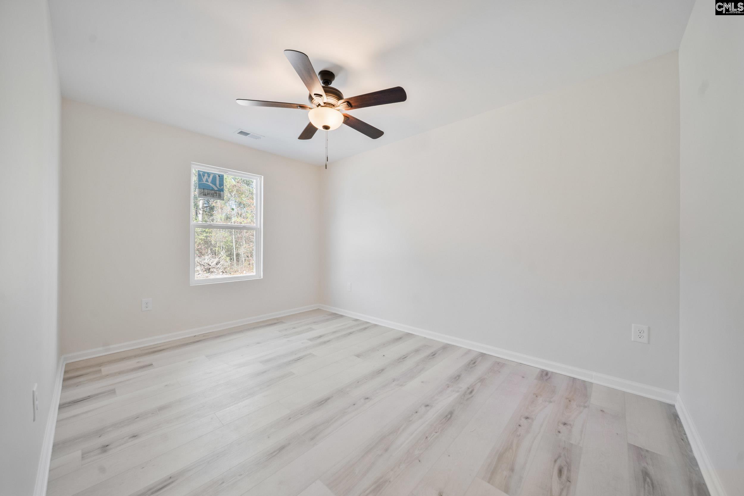 116 Sunny Acres Road Eastover, SC 29044 - Photo 17 of 40 an empty room with windows and fan