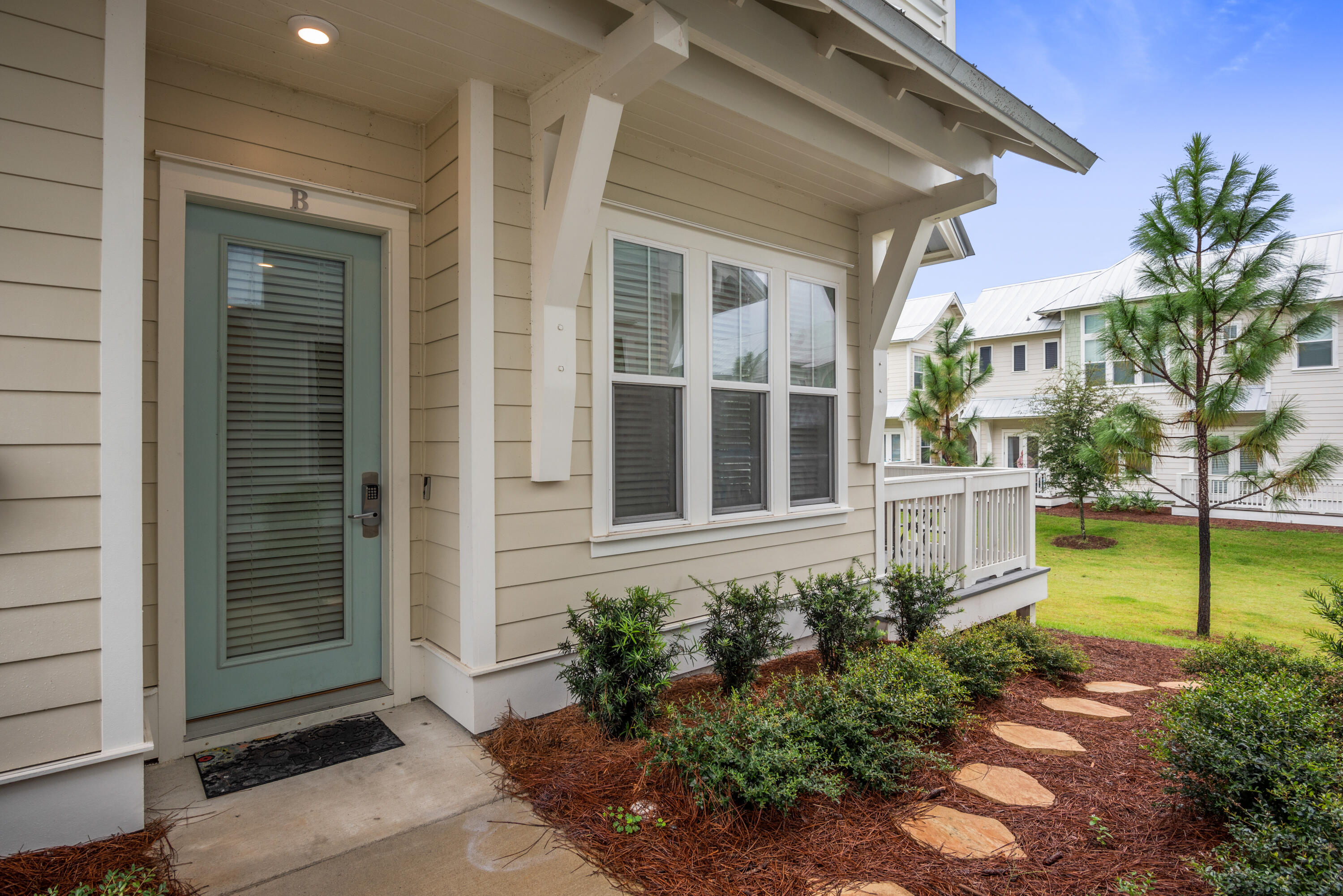 296 Milestone Dr Inlet Beach, Unit B Inlet Beach, FL 32461 - Photo 21 of 47 a view of a house with a garden
