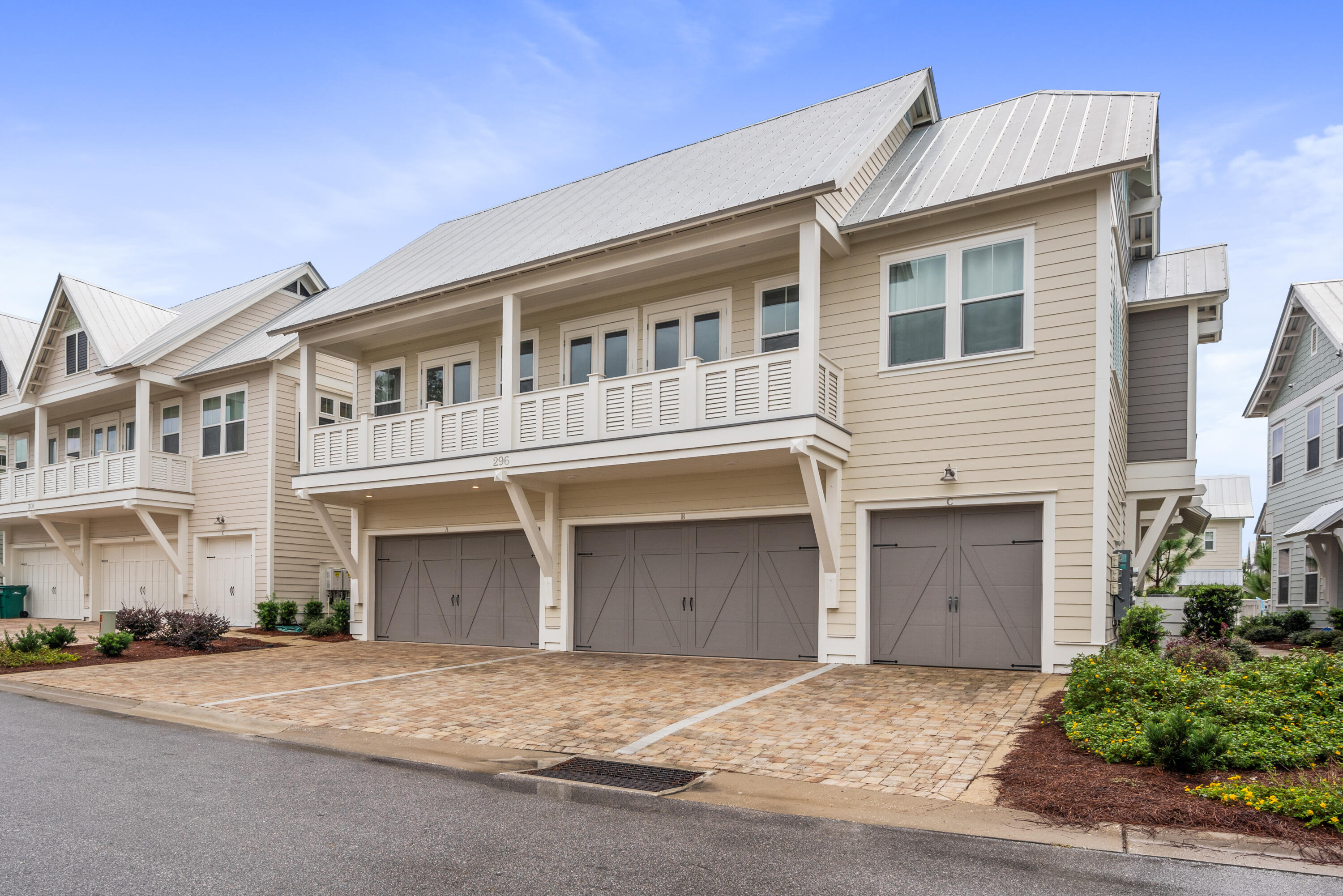 296 Milestone Dr Inlet Beach, Unit B Inlet Beach, FL 32461 - Photo 22 of 47 a front view of a house with a yard and garage