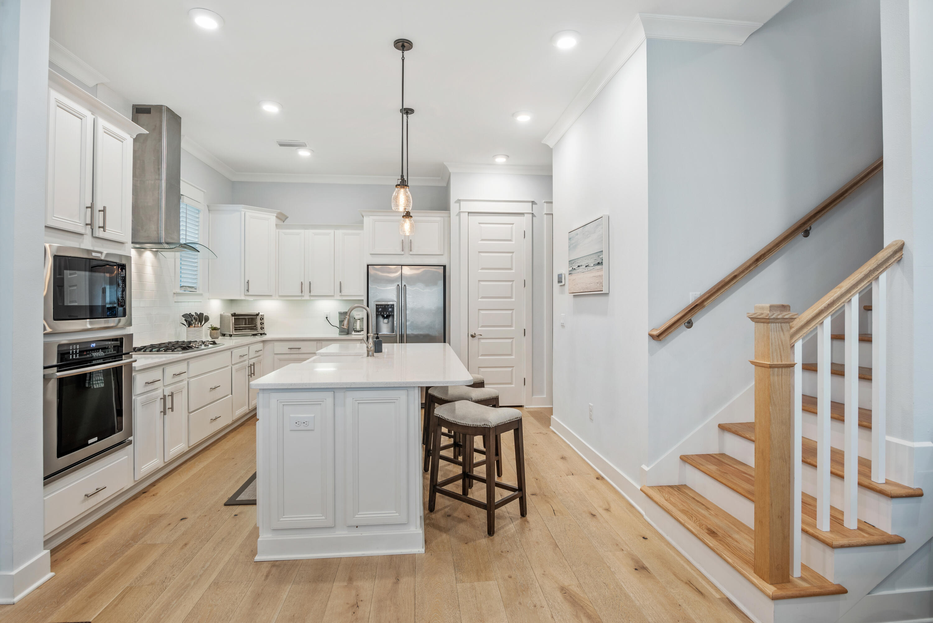 296 Milestone Dr Inlet Beach, Unit B Inlet Beach, FL 32461 - Photo 5 of 47 a kitchen with cabinets and wooden floor