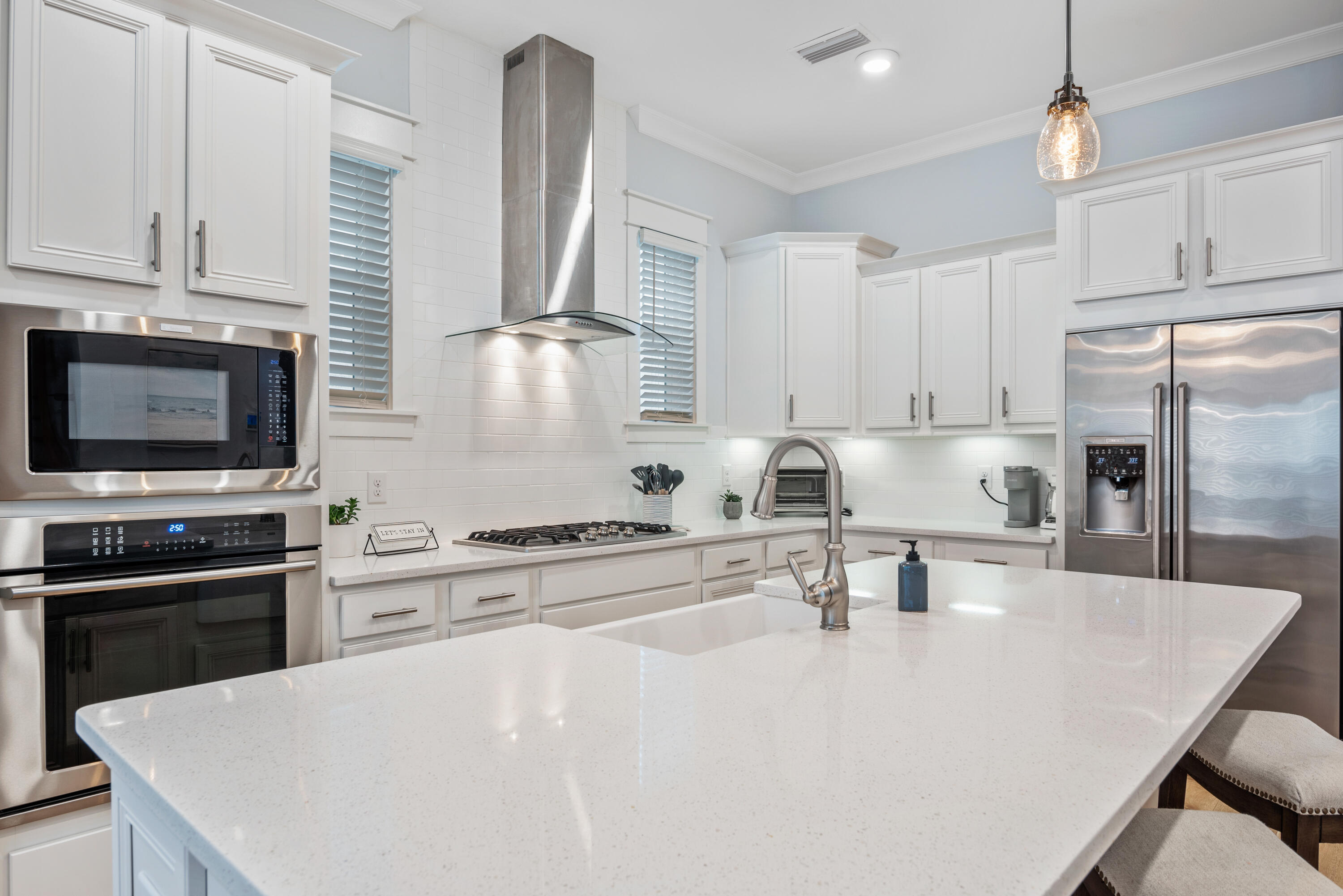 296 Milestone Dr Inlet Beach, Unit B Inlet Beach, FL 32461 - Photo 6 of 47 a kitchen with stainless steel appliances a stove sink microwave and cabinets
