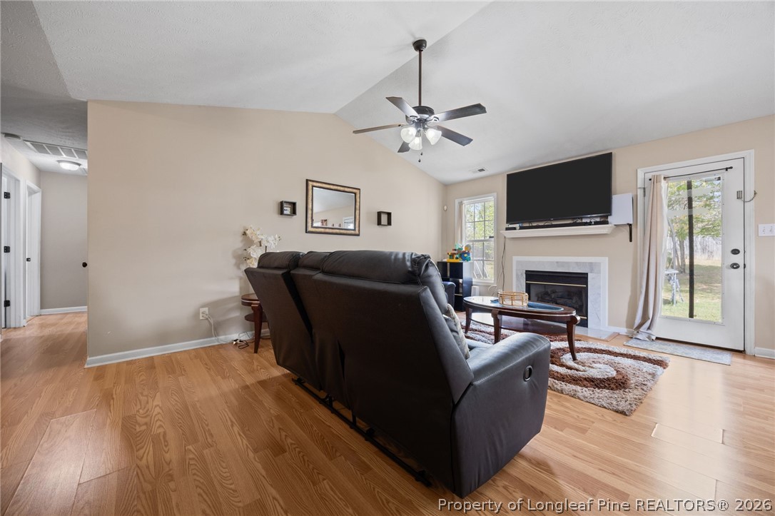236 Proclamation Drive Raeford, NC 28376 - Photo 17 of 43 a living room with furniture and a fireplace
