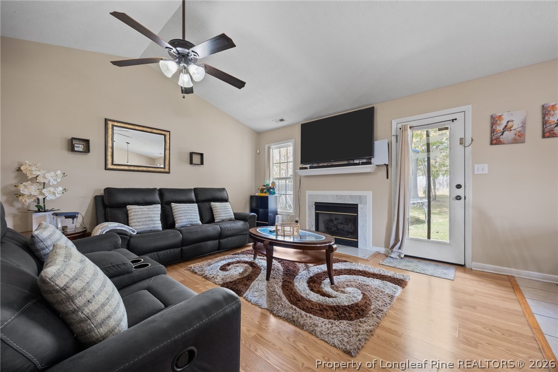 236 Proclamation Drive Raeford, NC 28376 - Photo 18 of 43 a living room with furniture a flat screen tv and a fireplace