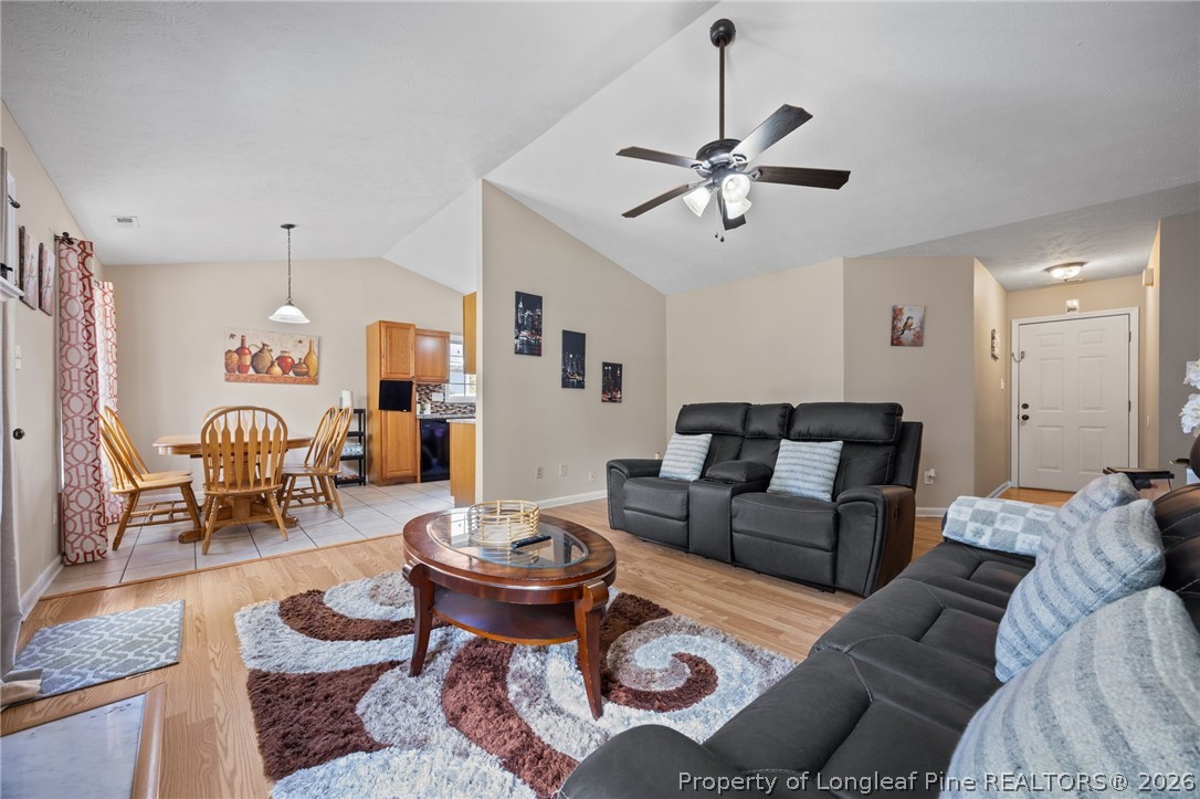 236 Proclamation Drive Raeford, NC 28376 - Photo 20 of 43 a living room with furniture a rug and a chandelier