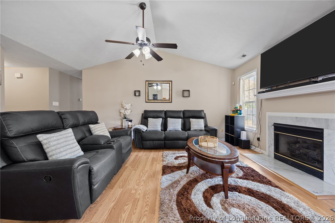 236 Proclamation Drive Raeford, NC 28376 - Photo 21 of 43 a living room with furniture a flat screen tv and a fireplace