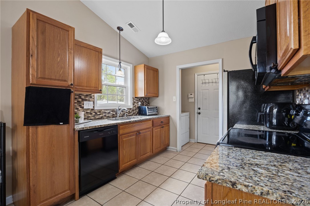 236 Proclamation Drive Raeford, NC 28376 - Photo 26 of 43 a kitchen with stainless steel appliances granite countertop a refrigerator and a sink