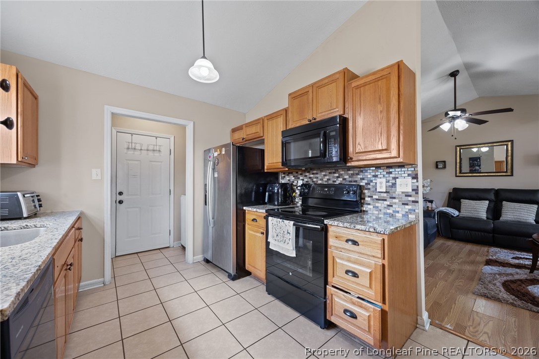236 Proclamation Drive Raeford, NC 28376 - Photo 27 of 43 a kitchen with stainless steel appliances granite countertop a sink and a stove