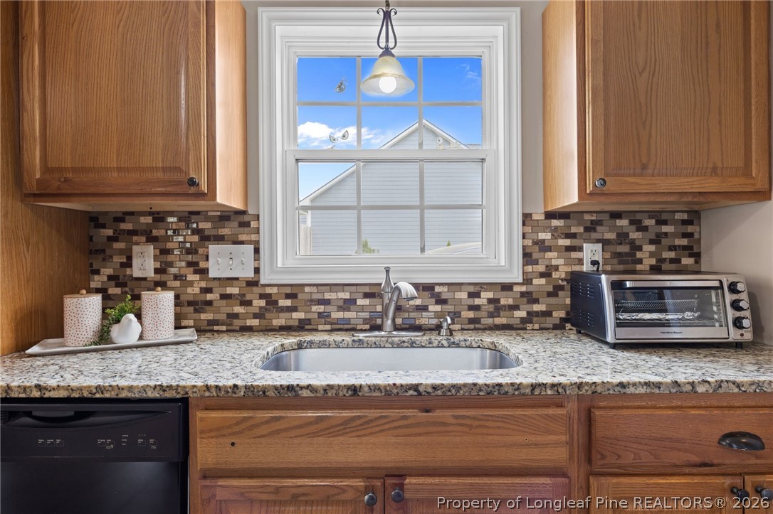 236 Proclamation Drive Raeford, NC 28376 - Photo 29 of 43 a kitchen with granite countertop a sink and a stove
