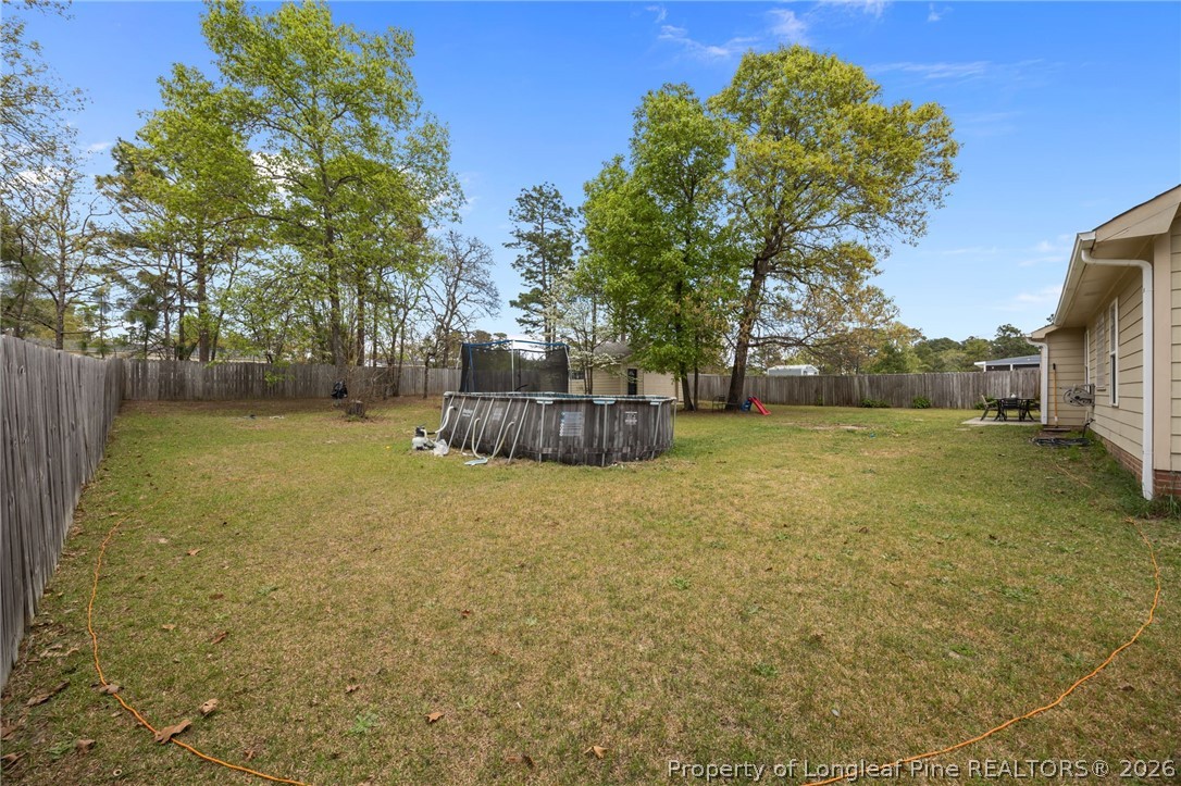 236 Proclamation Drive Raeford, NC 28376 - Photo 37 of 43 a backyard of a house with a yard and tree