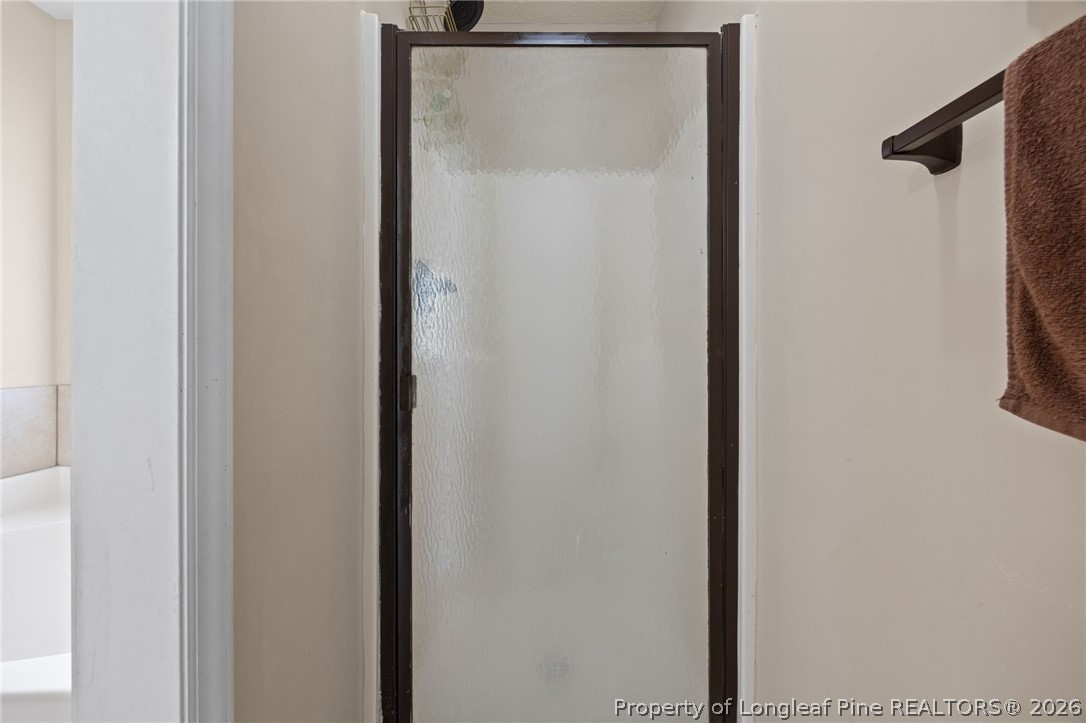 236 Proclamation Drive Raeford, NC 28376 - Photo 6 of 43 a bathroom with a glass shower door
