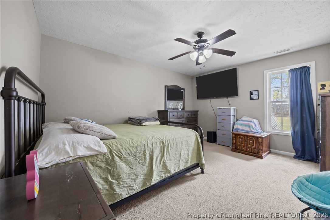 236 Proclamation Drive Raeford, NC 28376 - Photo 7 of 43 a bedroom with a bed and a chandelier