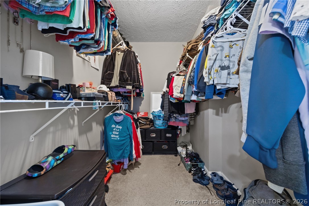 236 Proclamation Drive Raeford, NC 28376 - Photo 9 of 43 a view of walk in closet with clothes and shoes