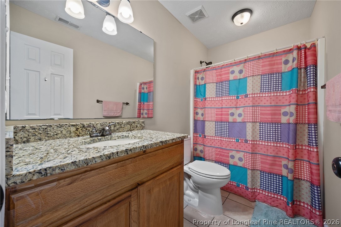 236 Proclamation Drive Raeford, NC 28376 - Photo 10 of 43 a bathroom with a sink toilet vanity and shower