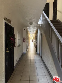 a hallway with dining area and chandelier