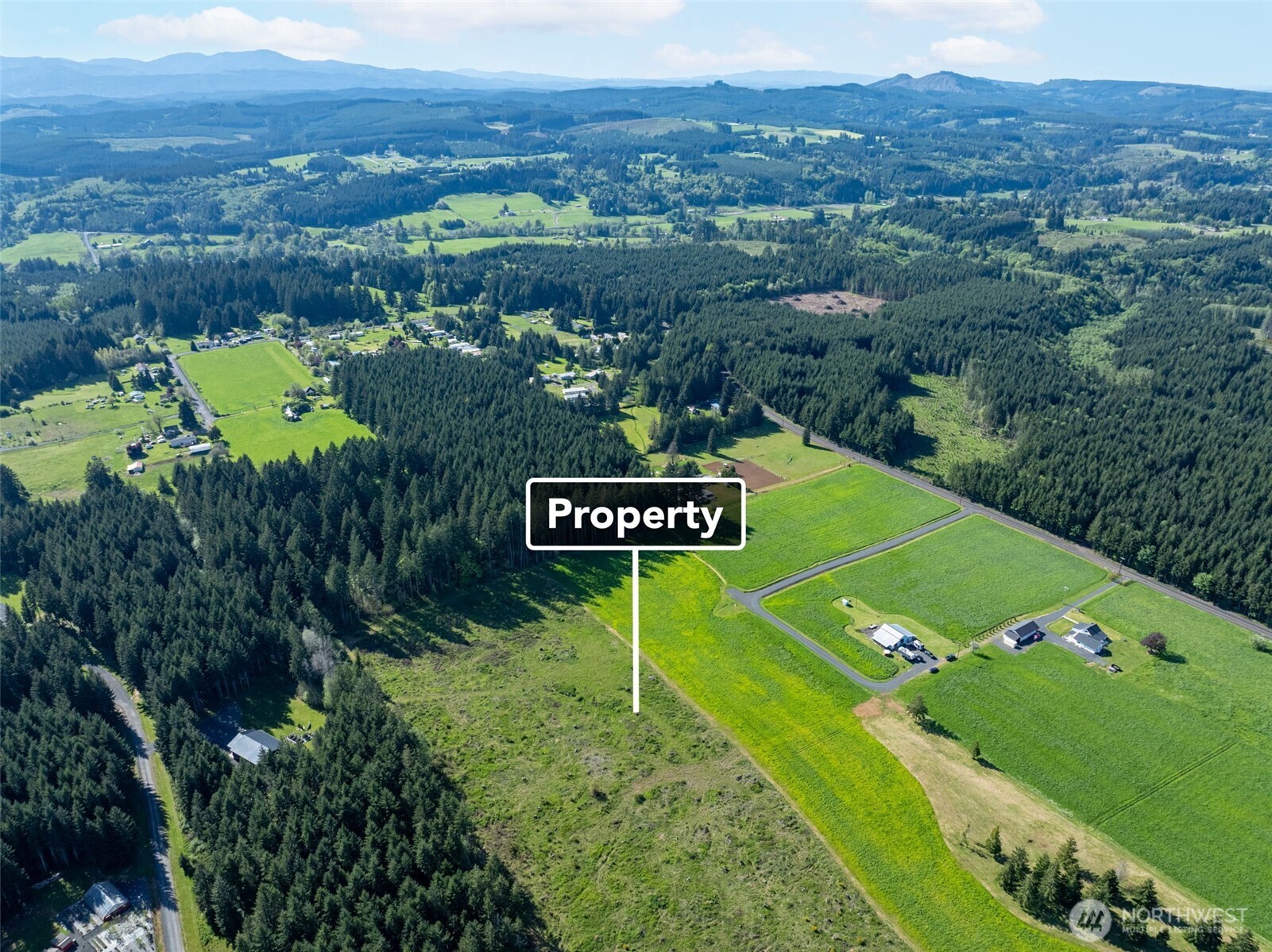0 McGlaughlin Road, Unit 3 Winlock, WA 98596 - Photo 4 of 13 a sign that is sitting on a lush green field