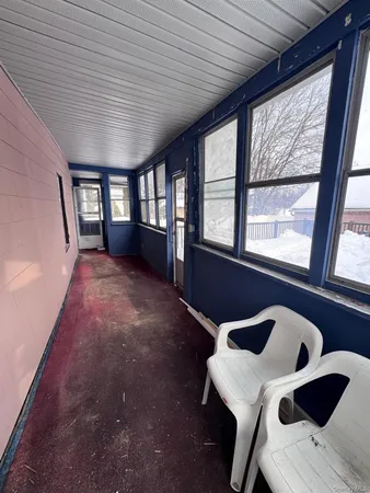 a view of an empty room with a balcony and window