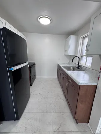 a white toilet sitting next to a sink and vanity