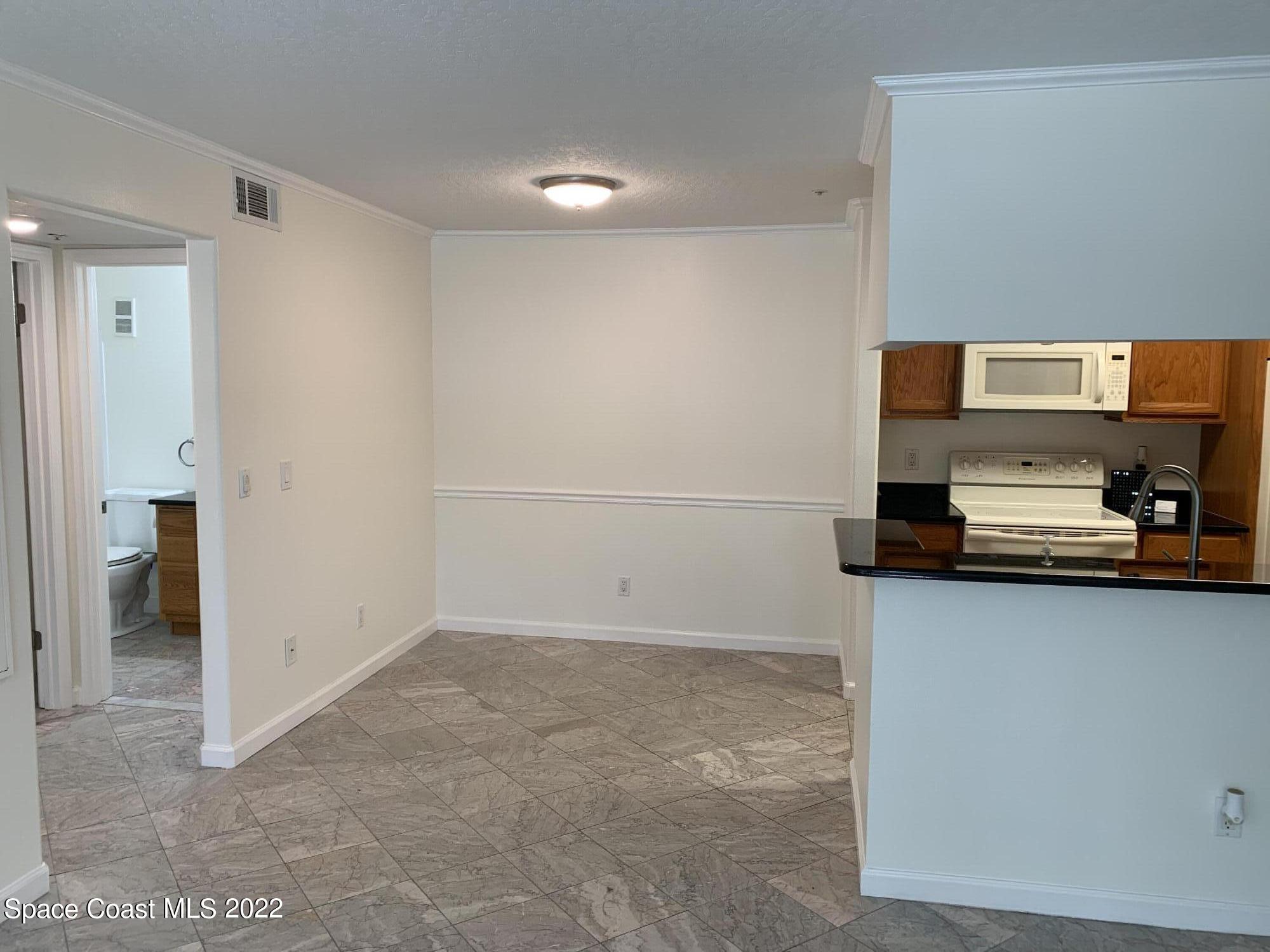 7667 North Wickham Road, Unit 612 Melbourne, FL 32940 - Photo 4 of 21 a view of kitchen and utility room