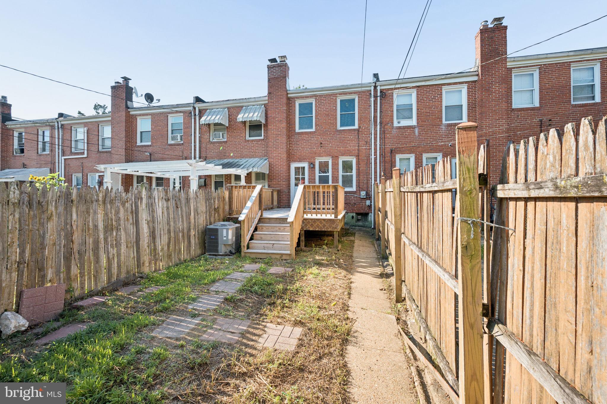 3548 Benzinger Road Baltimore, MD 21229 - Photo 35 of 40 a view of a brick house with many windows next to a yard
