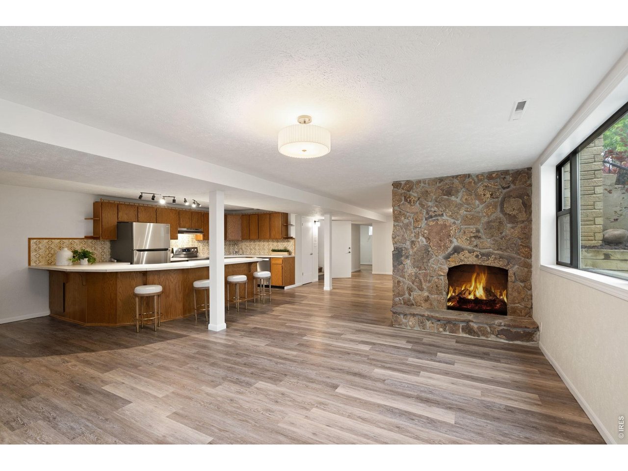 1118 Ridgelawn Drive Fort Collins, CO 80521 - Photo 22 of 48 The area is divided by a wood burning stone fireplace