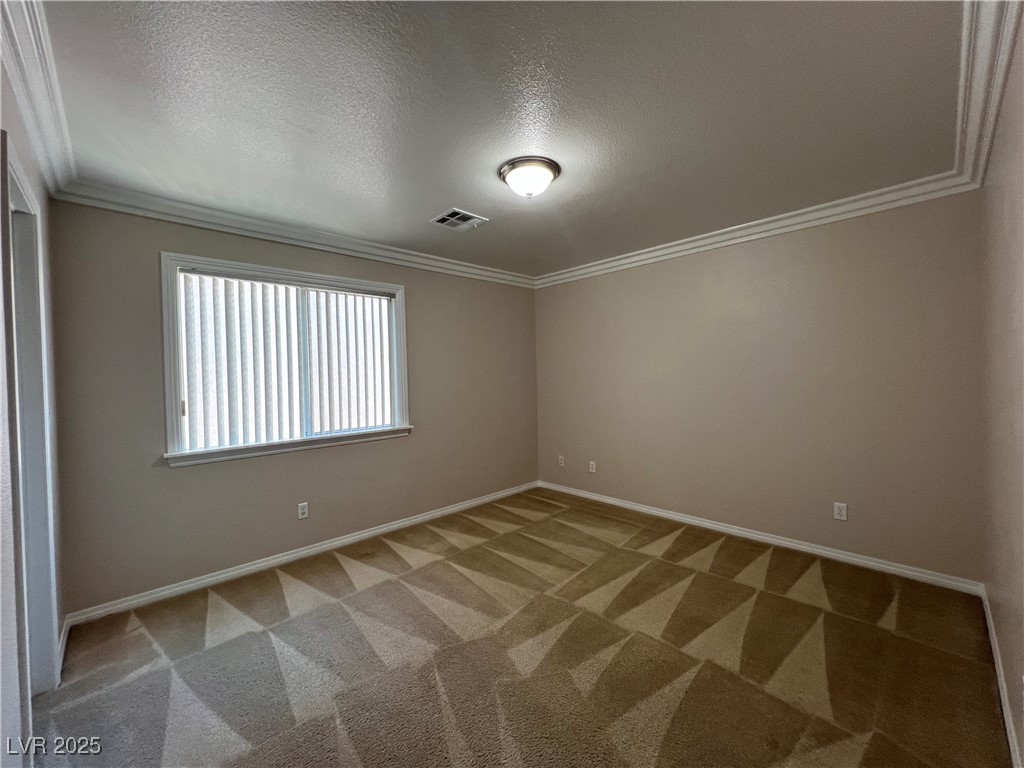 7195 Cestrum Road Las Vegas, NV 89113 - Photo 13 of 33 Spare room with carpet floors, baseboards, crown m