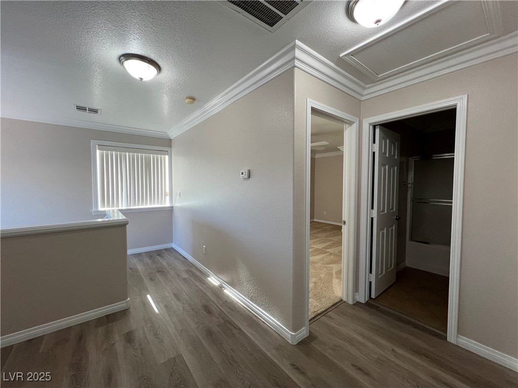 7195 Cestrum Road Las Vegas, NV 89113 - Photo 17 of 33 Hallway with wood finished floors, crown molding,