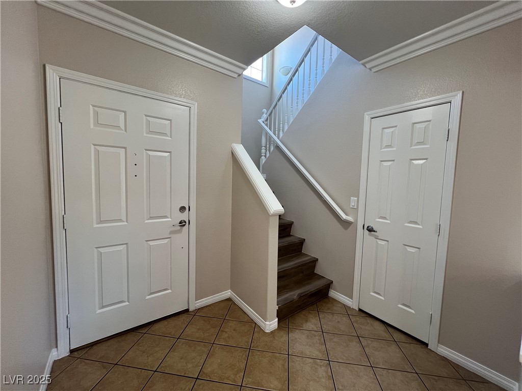 7195 Cestrum Road Las Vegas, NV 89113 - Photo 2 of 33 Foyer featuring tile patterned flooring, stairs, a