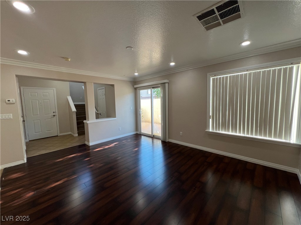 7195 Cestrum Road Las Vegas, NV 89113 - Photo 4 of 33 Spare room with stairs, hardwood / wood-style floo