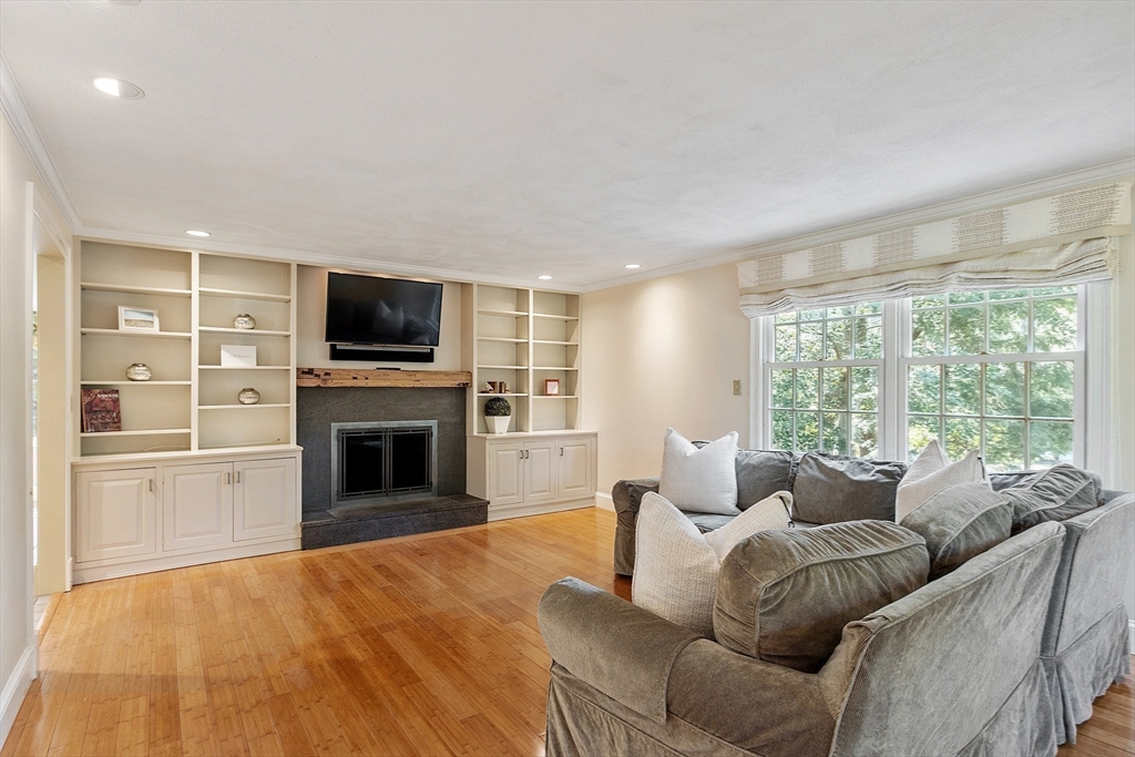 1 Seneca Circle Andover, MA 01810 - Photo 19 of 40 a living room with furniture a fireplace and a flat screen tv