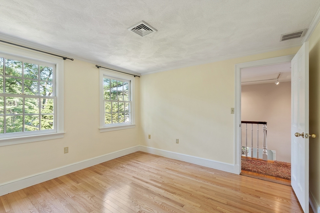1 Seneca Circle Andover, MA 01810 - Photo 30 of 40 an empty room with wooden floor and windows