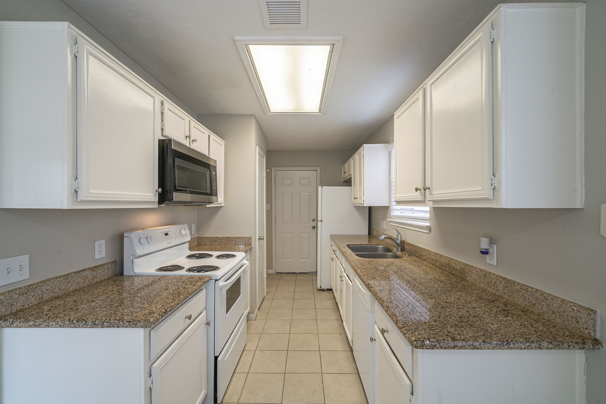 4011 Monteith Drive Spring, TX 77373 - Photo 12 of 28 a kitchen with granite countertop a sink stainless steel appliances and cabinets