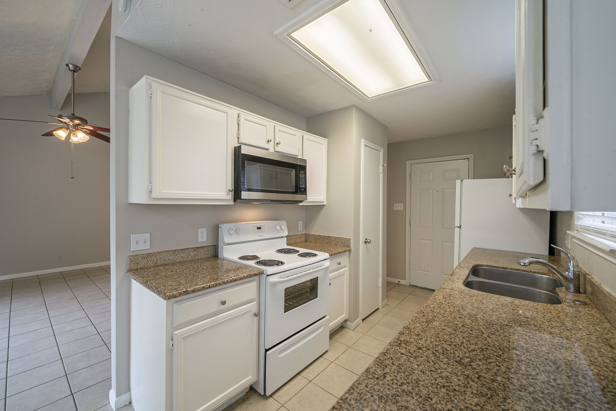 4011 Monteith Drive Spring, TX 77373 - Photo 13 of 28 a kitchen with a stove a sink and a microwave