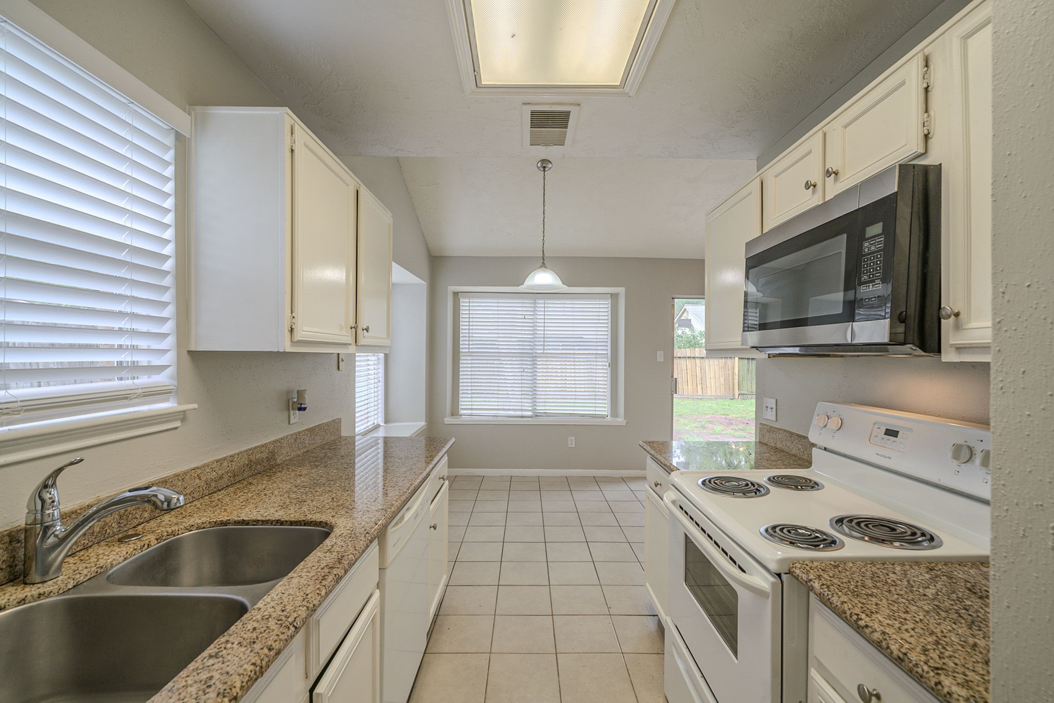 4011 Monteith Drive Spring, TX 77373 - Photo 14 of 28 a kitchen that has a sink and a stove