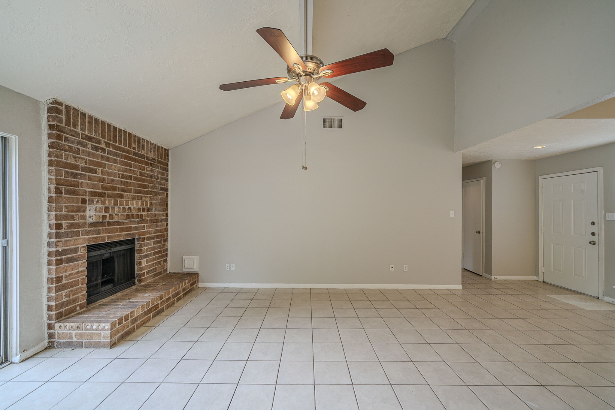 4011 Monteith Drive Spring, TX 77373 - Photo 9 of 28 a view of an empty room with chandelier fan and fire place
