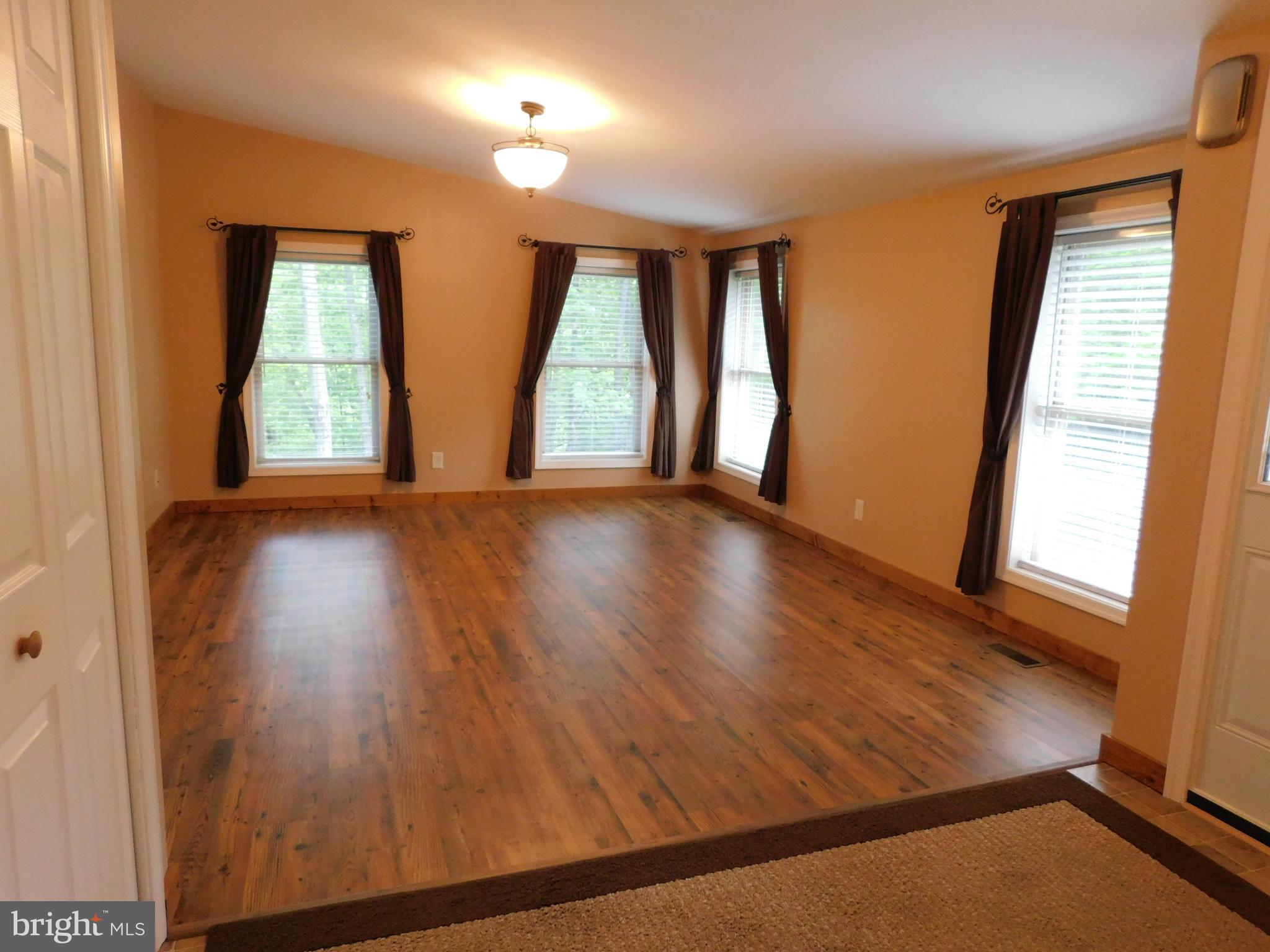 301 Animikean Ridge Hedgesville, WV 25427 - Photo 13 of 51 Wood laminate flooring in the dining room or den