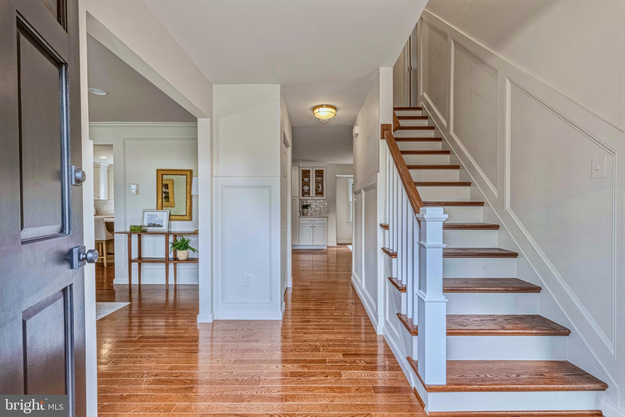 1331 Deep Run Lane Reston, VA 20190 - Photo 2 of 51 a view of staircase with lots of frames on wall and wooden floor
