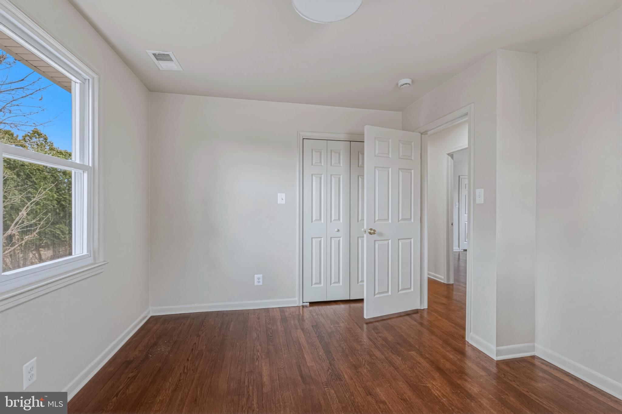 1331 Deep Run Lane Reston, VA 20190 - Photo 35 of 51 a view of an empty room with wooden floor and a window
