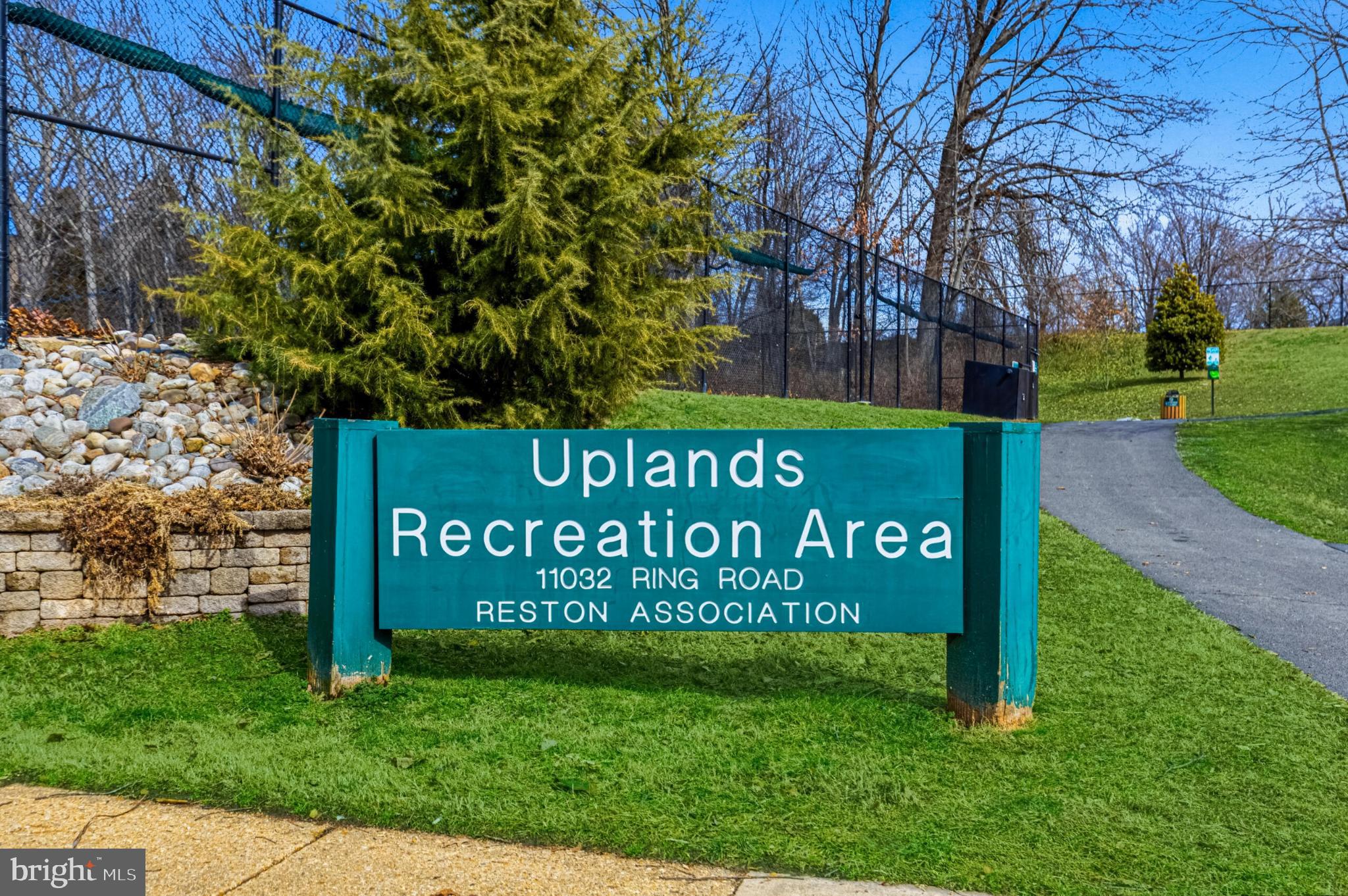 1331 Deep Run Lane Reston, VA 20190 - Photo 48 of 51 a sign of golf club on a wall under a tree