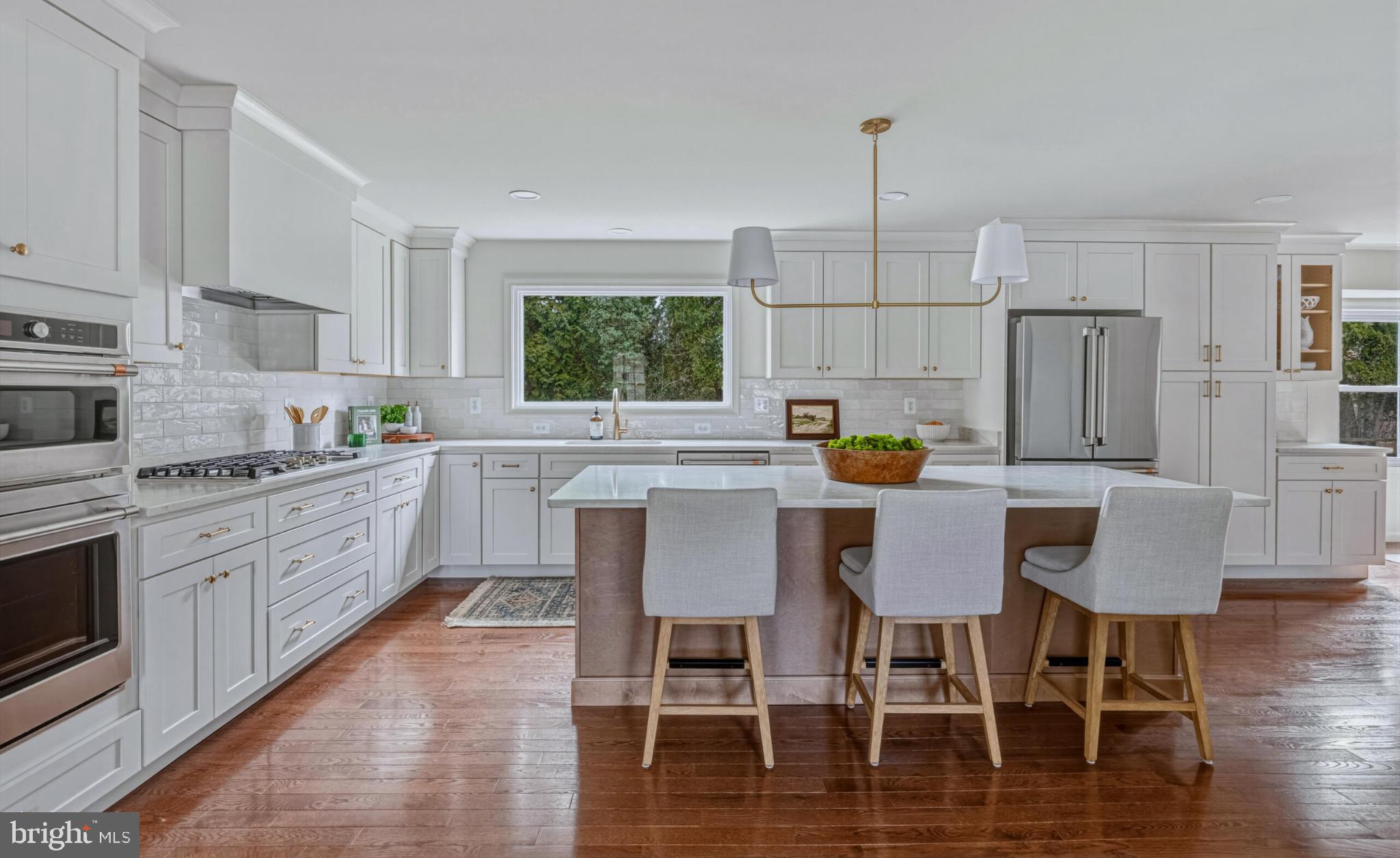 1331 Deep Run Lane Reston, VA 20190 - Photo 8 of 51 a kitchen with stainless steel appliances granite countertop a dining table chairs refrigerator and sink