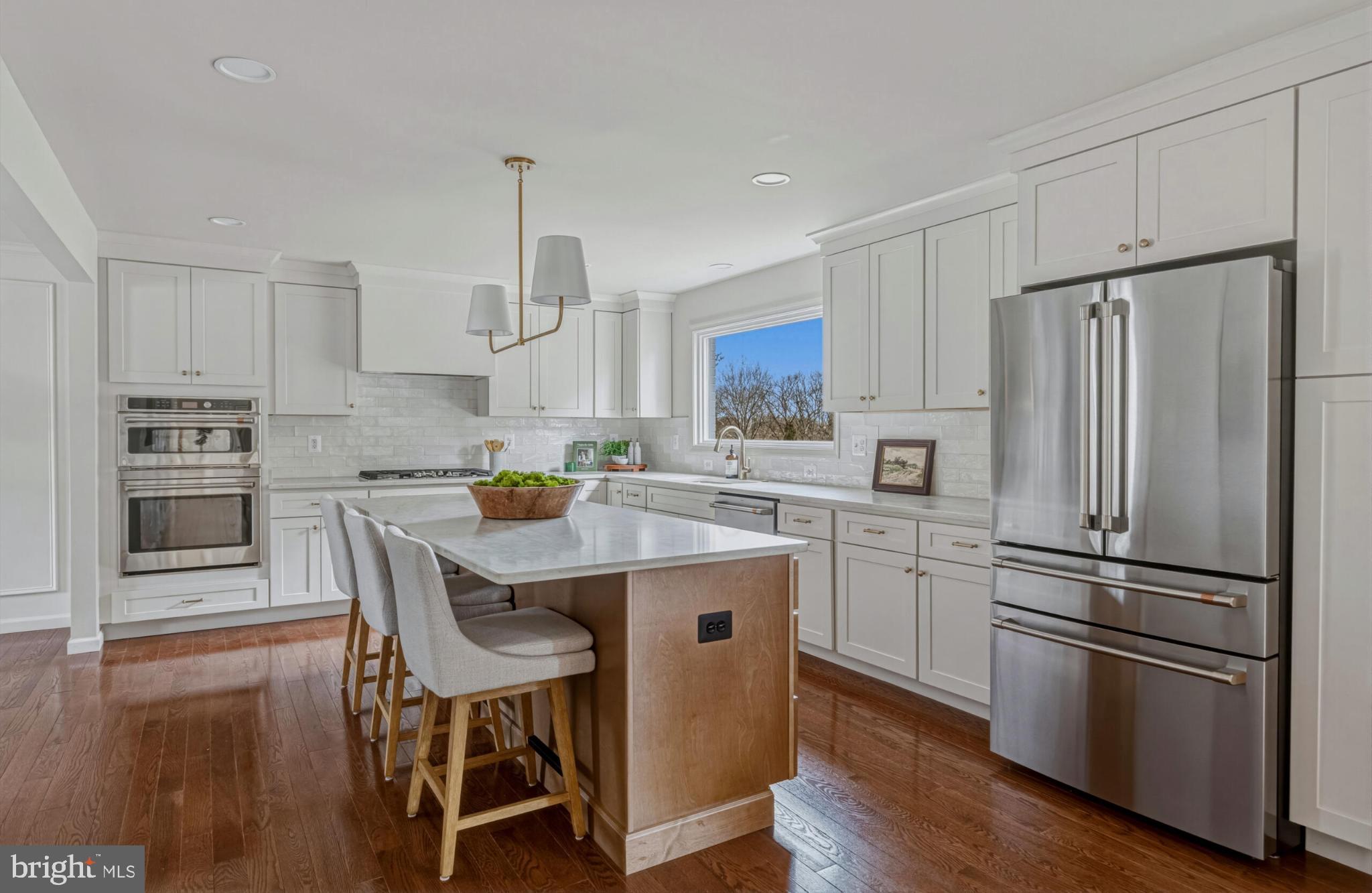 1331 Deep Run Lane Reston, VA 20190 - Photo 10 of 51 a kitchen with stainless steel appliances a refrigerator a stove a dining table and chairs