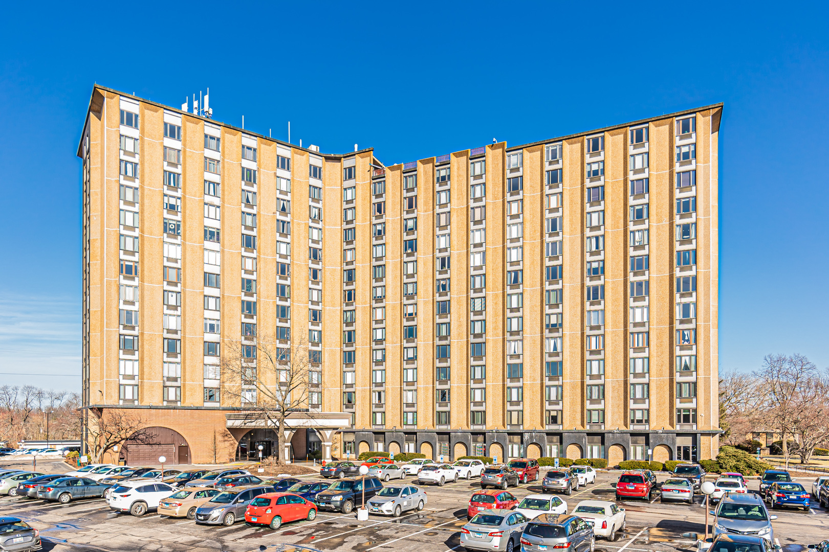 a city view with tall buildings and cars parked in front of it