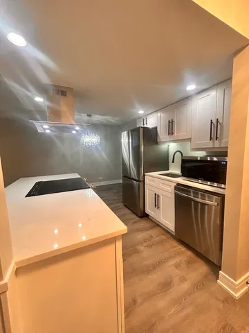 a kitchen with stainless steel appliances a refrigerator and a stove
