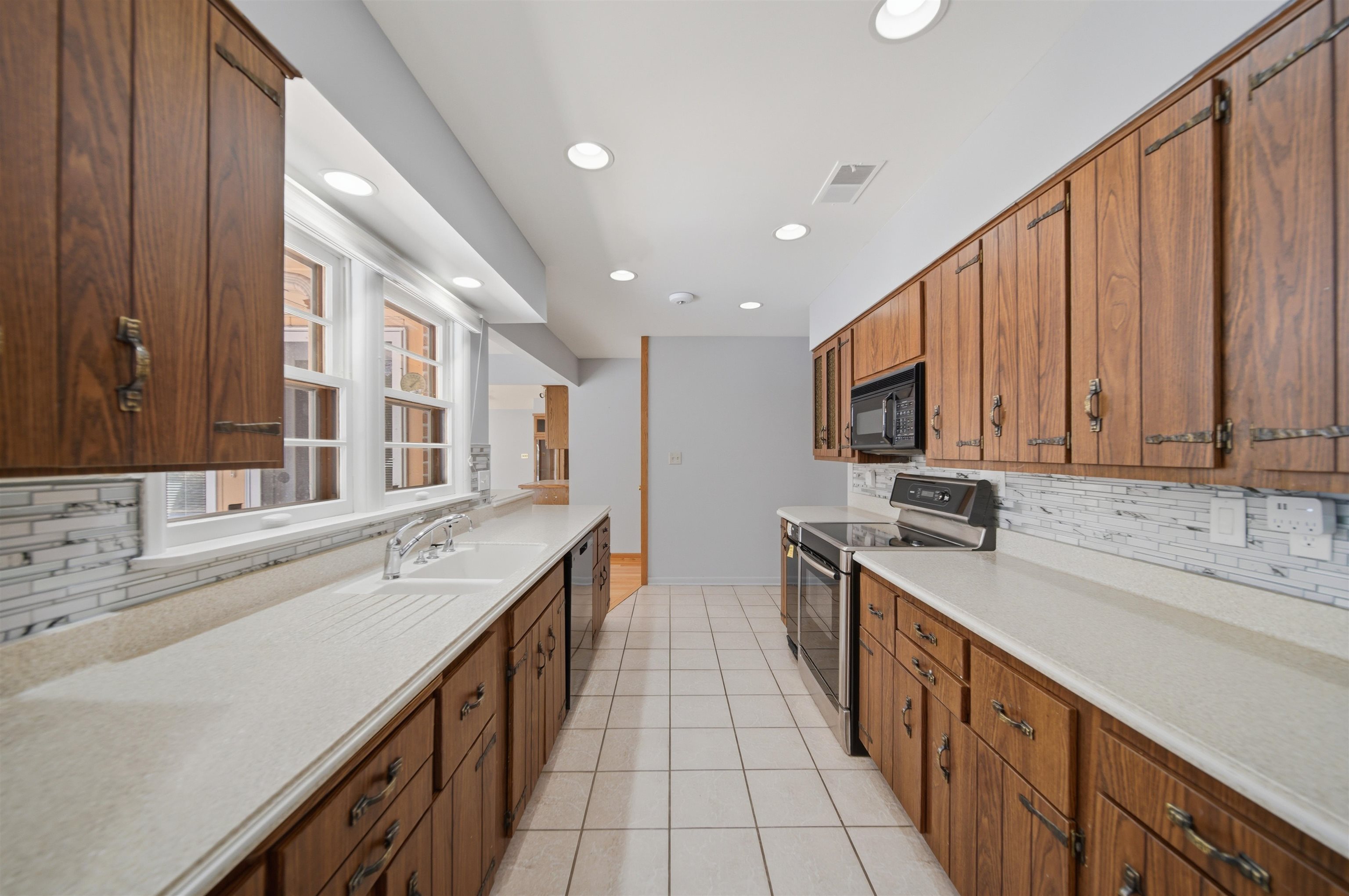 1213 Douglas Terrace Dixon, IL 61021 - Photo 15 of 49 a large kitchen with stainless steel appliances granite countertop a sink and cabinets