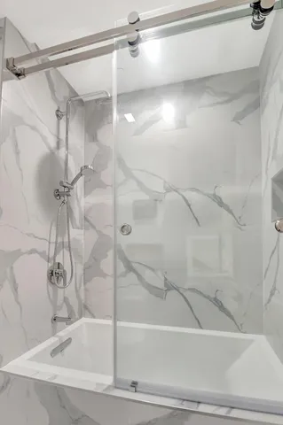 a bathroom with a bathtub and a shower