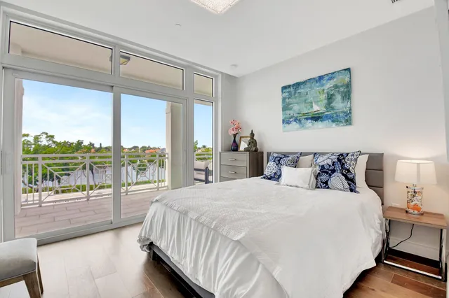 a bedroom with a large bed and a balcony view