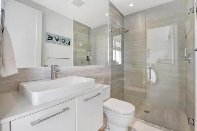 a bathroom with a sink toilet and shower